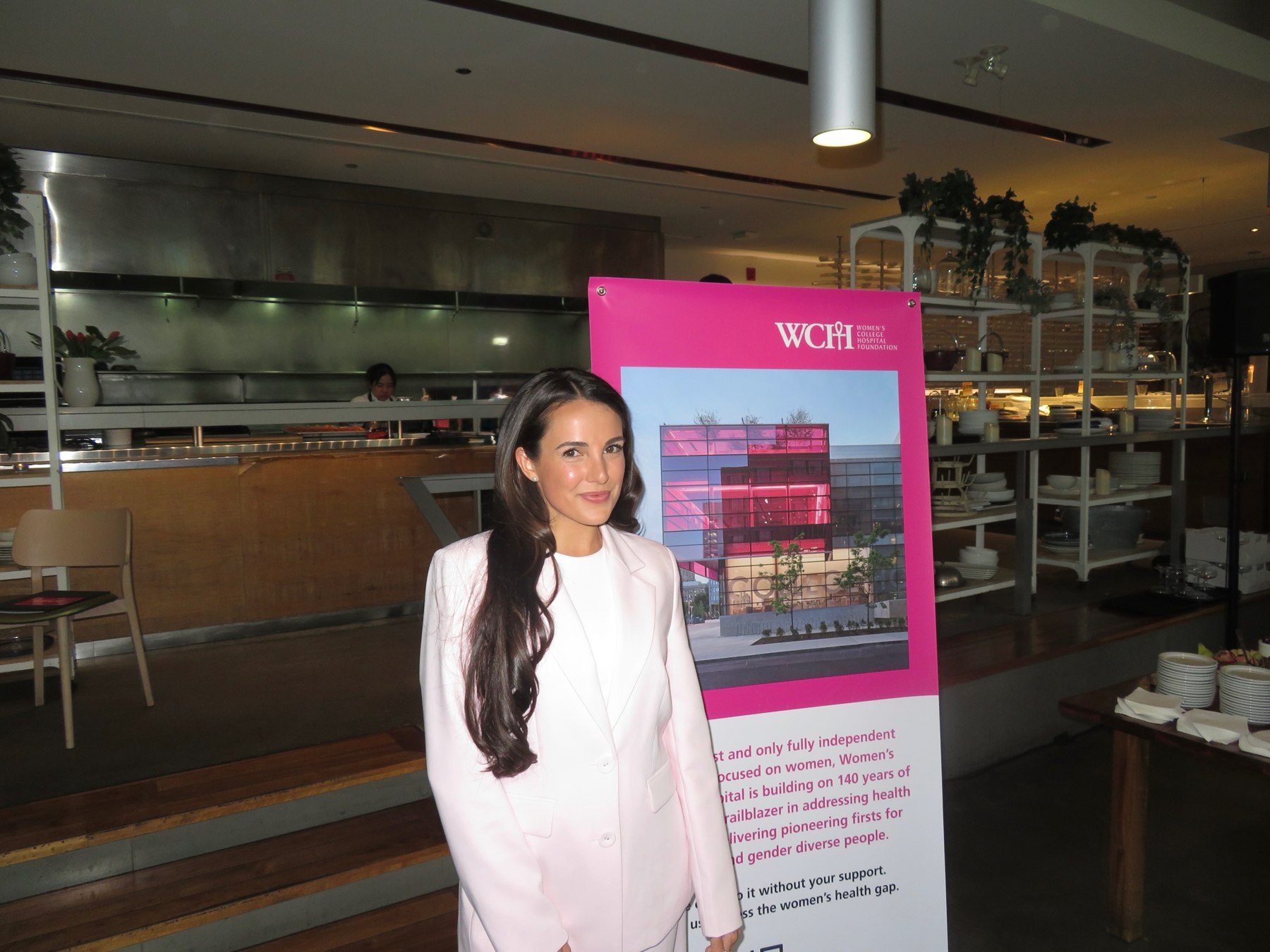 Dr. Emilie Vos beside the Women's College Hospital Foundation banner