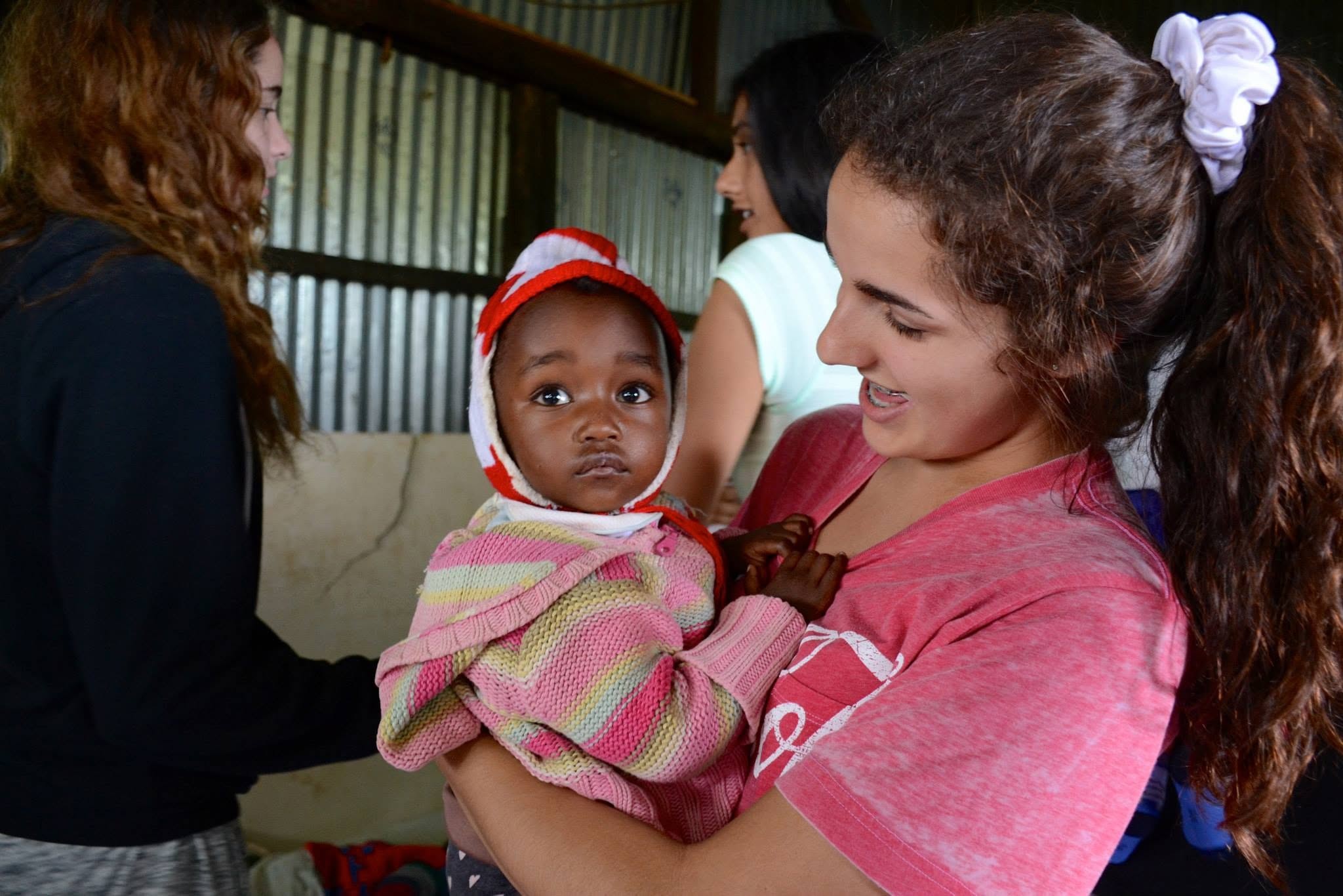 Dr. Emilie Vos holding a baby, Kenya